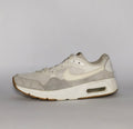 cream and light grey Nike Air Max SC sneaker featuring a visible Max Air unit and a classic gum rubber outsole.