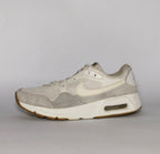cream and light grey Nike Air Max SC sneaker featuring a visible Max Air unit and a classic gum rubber outsole.
