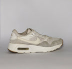 cream and light grey Nike Air Max SC sneaker featuring a visible Max Air unit and a classic gum rubber outsole.