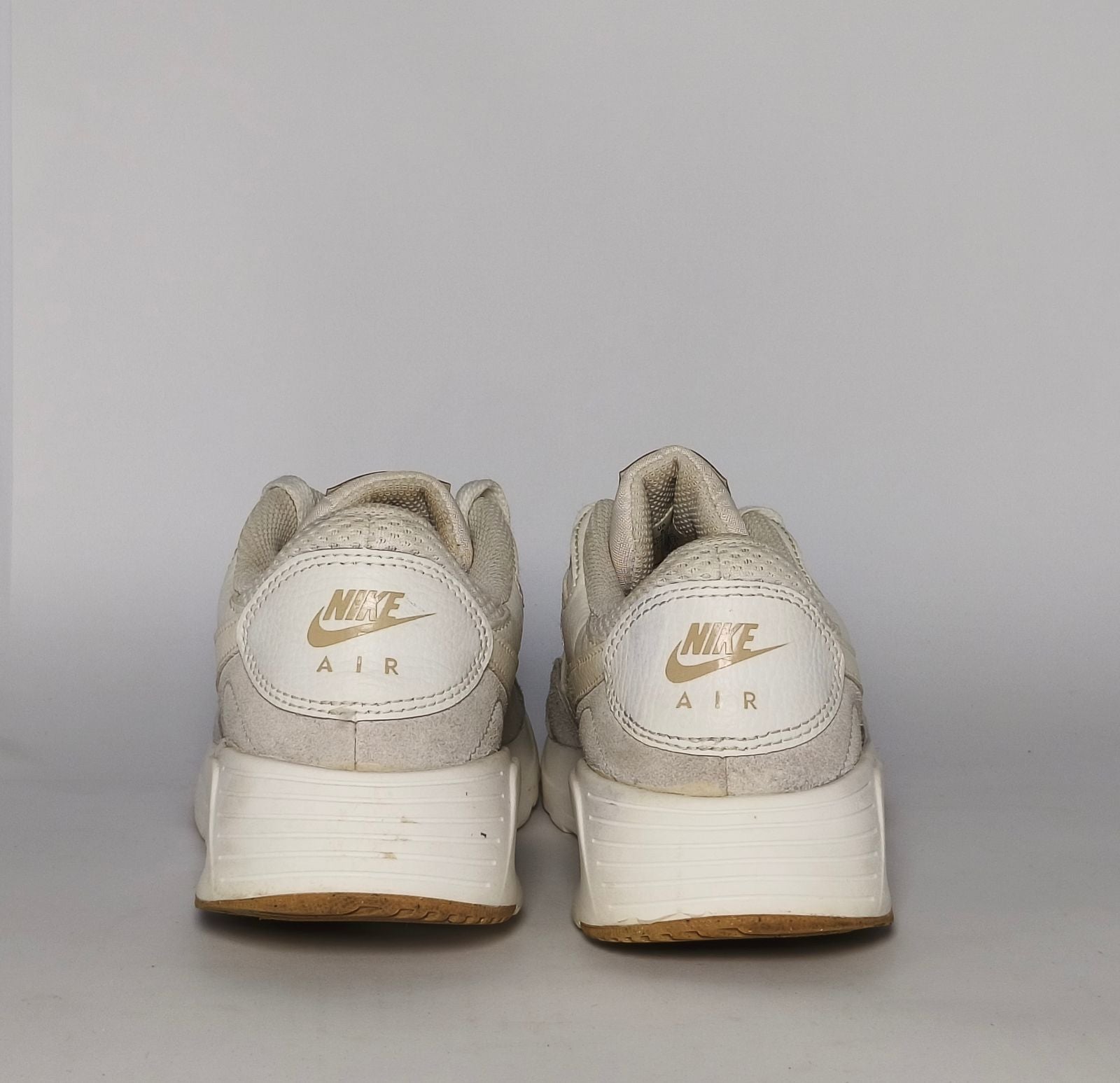 cream and light grey Nike Air Max SC sneaker featuring a visible Max Air unit and a classic gum rubber outsole.