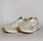 cream and light grey Nike Air Max SC sneaker featuring a visible Max Air unit and a classic gum rubber outsole.