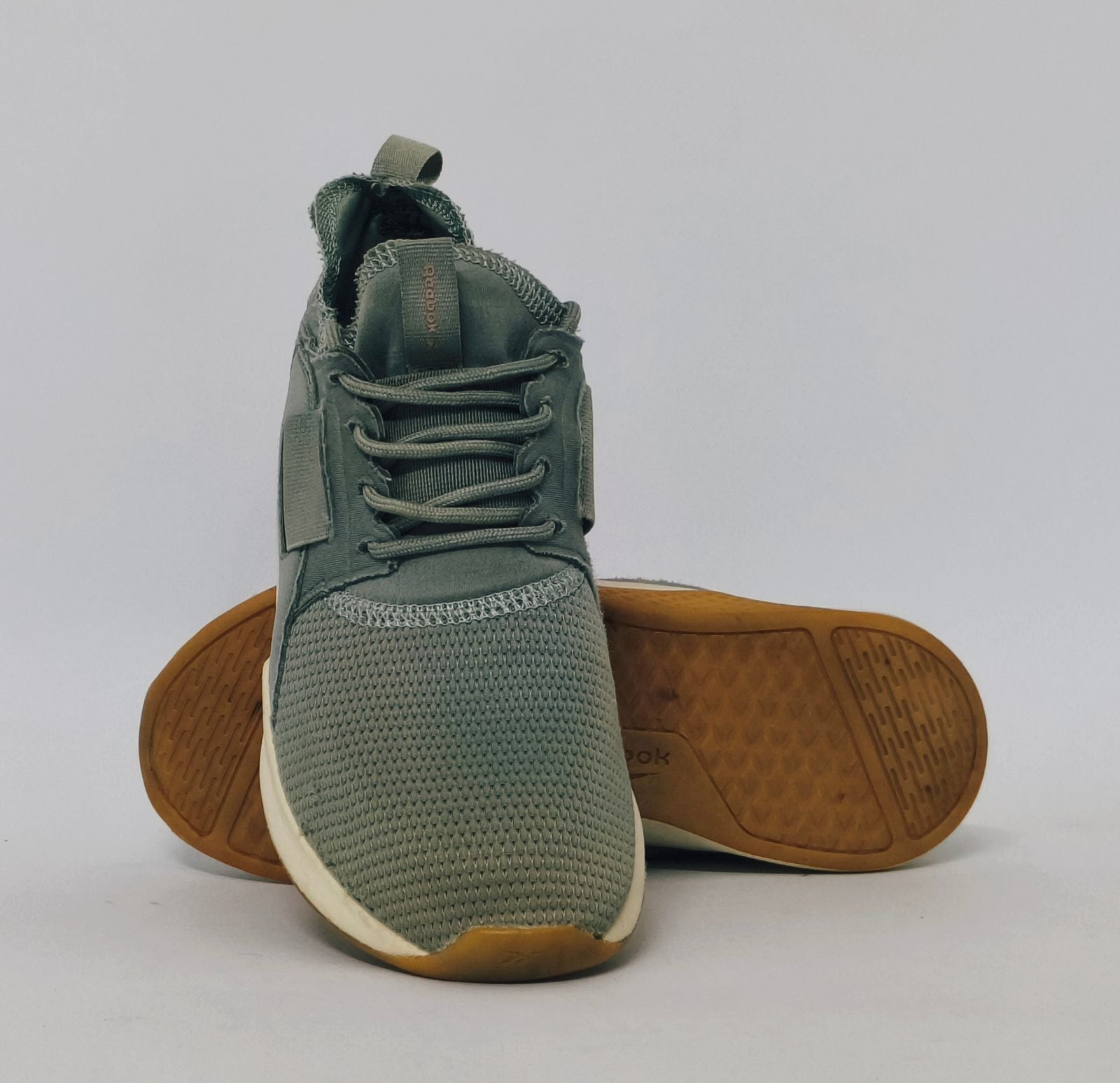 Reebok Nano cross-training shoe featuring a knit upper, cream midsole, and a gum rubber outsole.