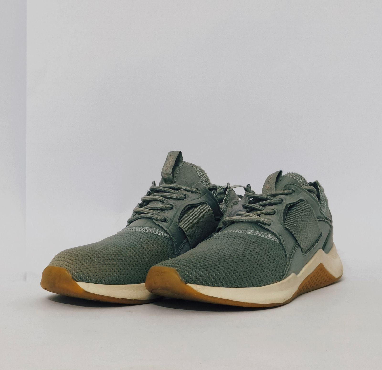 Reebok Nano cross-training shoe featuring a knit upper, cream midsole, and a gum rubber outsole.