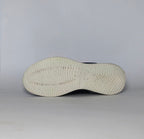 navy blue Skechers BOBS Squad sneaker featuring a white midsole and a textured knit upper.