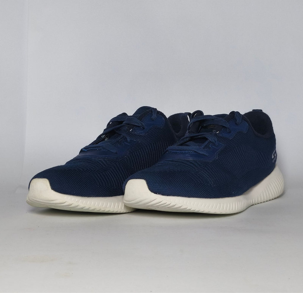 navy blue Skechers BOBS Squad sneaker featuring a white midsole and a textured knit upper.