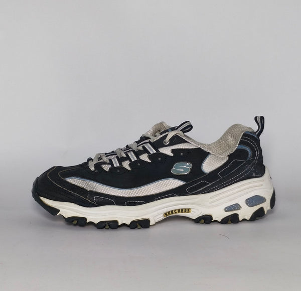 navy blue and silver Skechers D'Lites sneaker featuring a thick white midsole and a rugged black traction outsole.