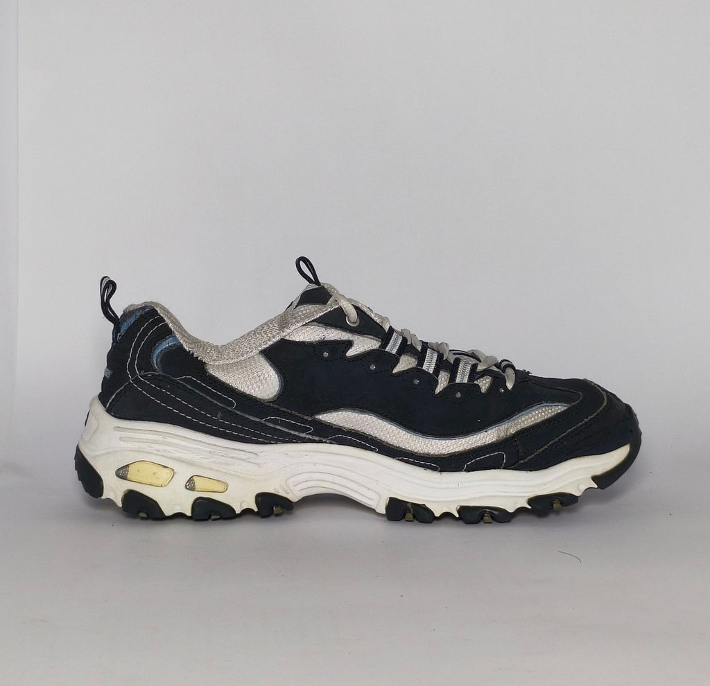navy blue and silver Skechers D'Lites sneaker featuring a thick white midsole and a rugged black traction outsole.