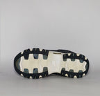 navy blue and silver Skechers D'Lites sneaker featuring a thick white midsole and a rugged black traction outsole.