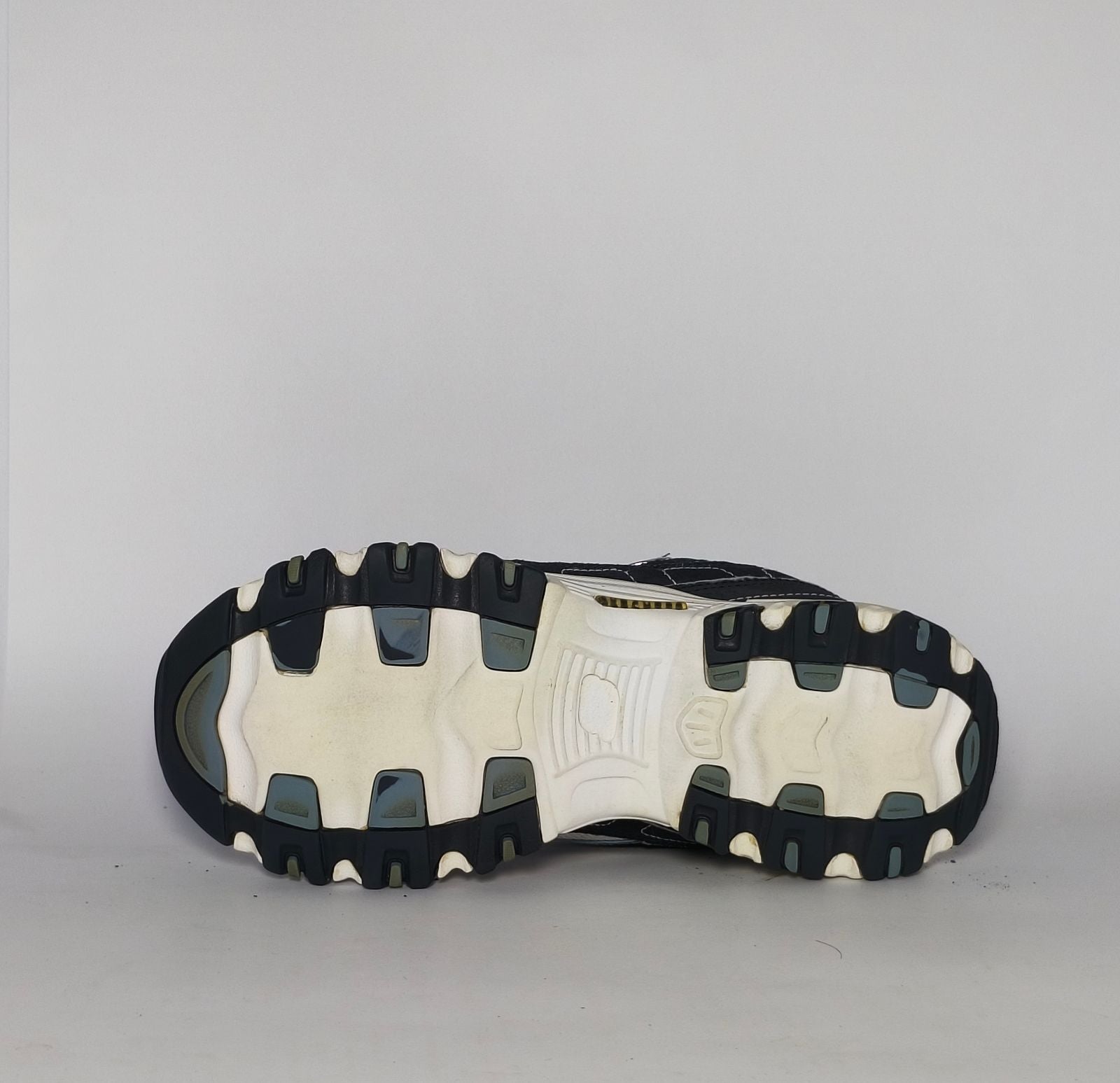 navy blue and silver Skechers D'Lites sneaker featuring a thick white midsole and a rugged black traction outsole.