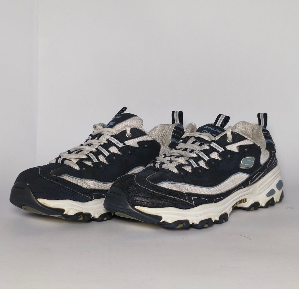 navy blue and silver Skechers D'Lites sneaker featuring a thick white midsole and a rugged black traction outsole.