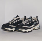 navy blue and silver Skechers D'Lites sneaker featuring a thick white midsole and a rugged black traction outsole.