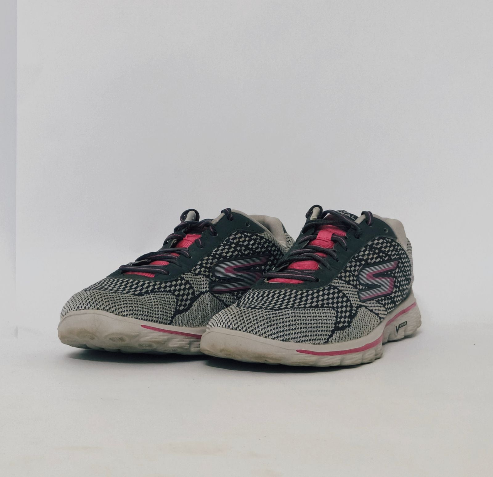 Grey and pink athletic sneakers with breathable knit upper and cushioned sole in used condition size US 8