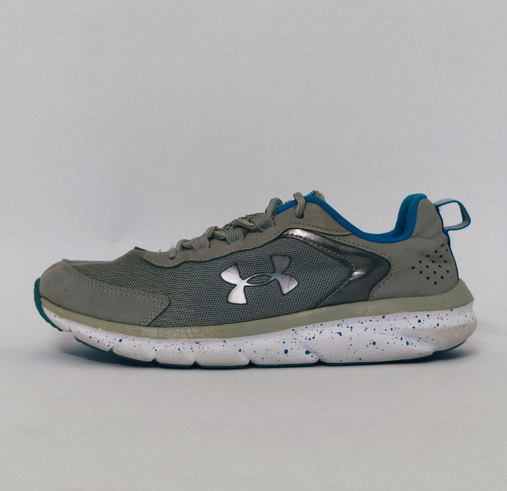 Under Armour training shoe with blue accents and a blue-speckled white midsole.