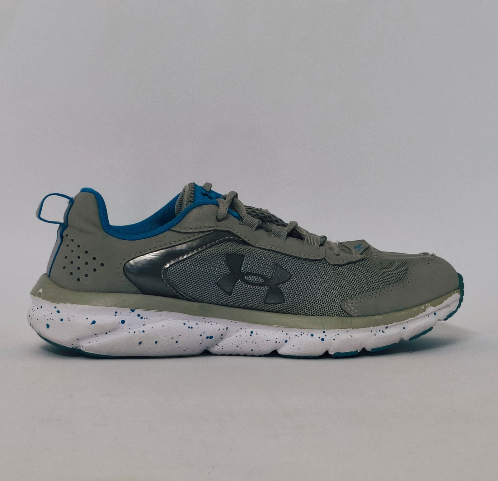 Under Armour training shoe with blue accents and a blue-speckled white midsole.
