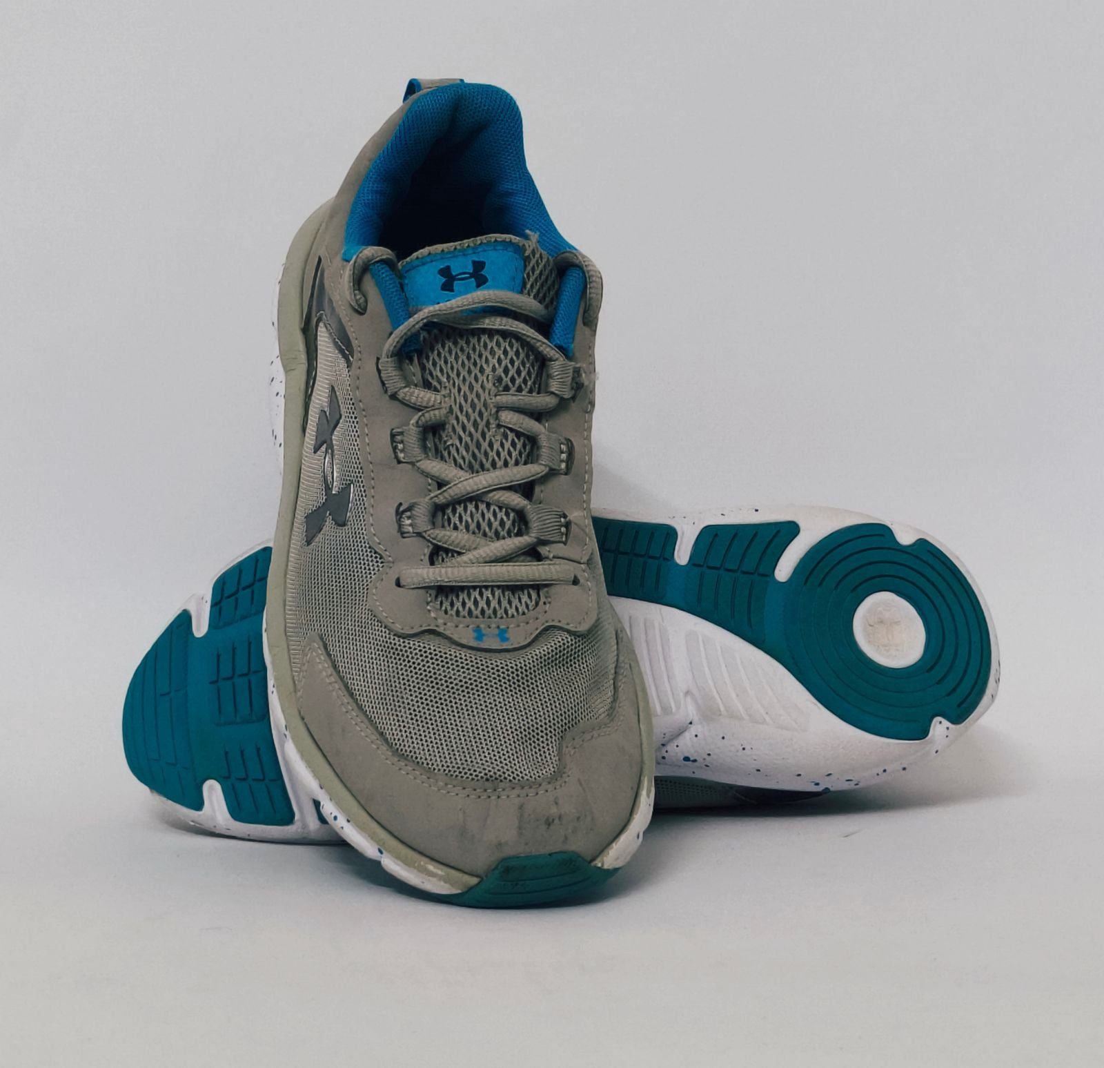 Under Armour training shoe with blue accents and a blue-speckled white midsole.