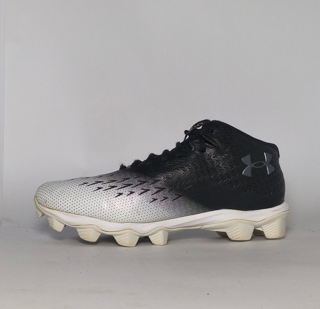 black and silver gradient Under Armour football cleat featuring a textured upper and a white molded cleat outsole.