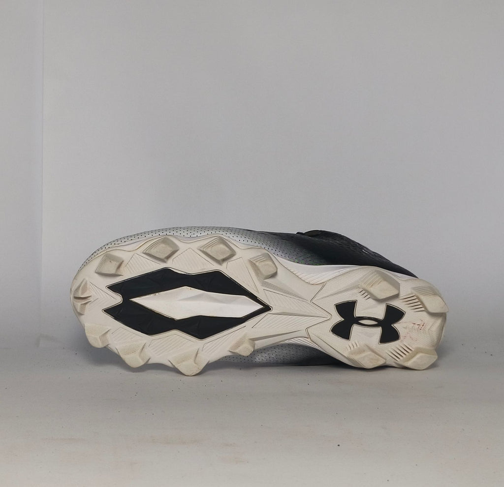 black and silver gradient Under Armour football cleat featuring a textured upper and a white molded cleat outsole.
