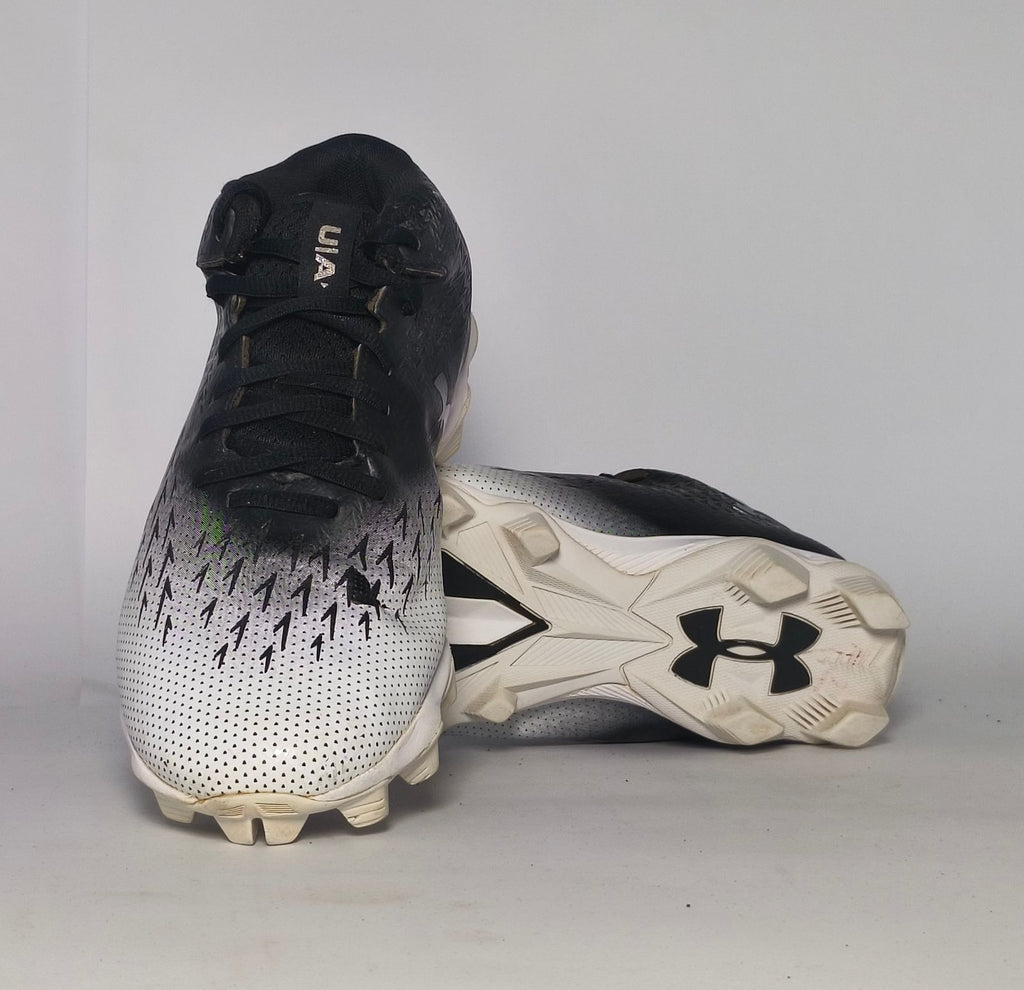 black and silver gradient Under Armour football cleat featuring a textured upper and a white molded cleat outsole.