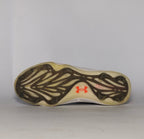 black Under Armour Harper baseball cleat featuring a white logo, white midsole, and a specialized cleated outsole for field traction.