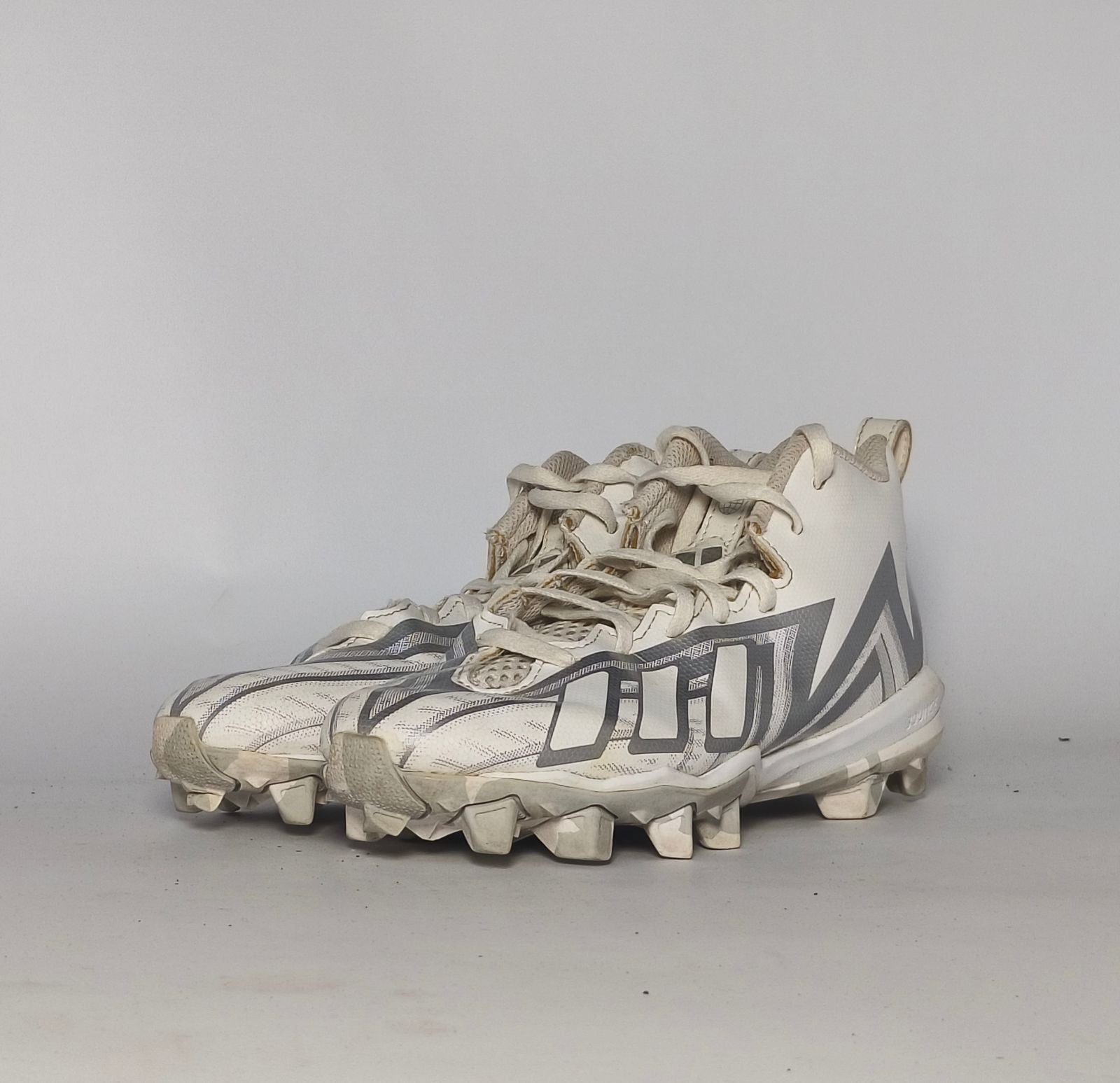 white and silver adidas Adizero football cleat featuring a geometric pattern and a cleated outsole for field traction.