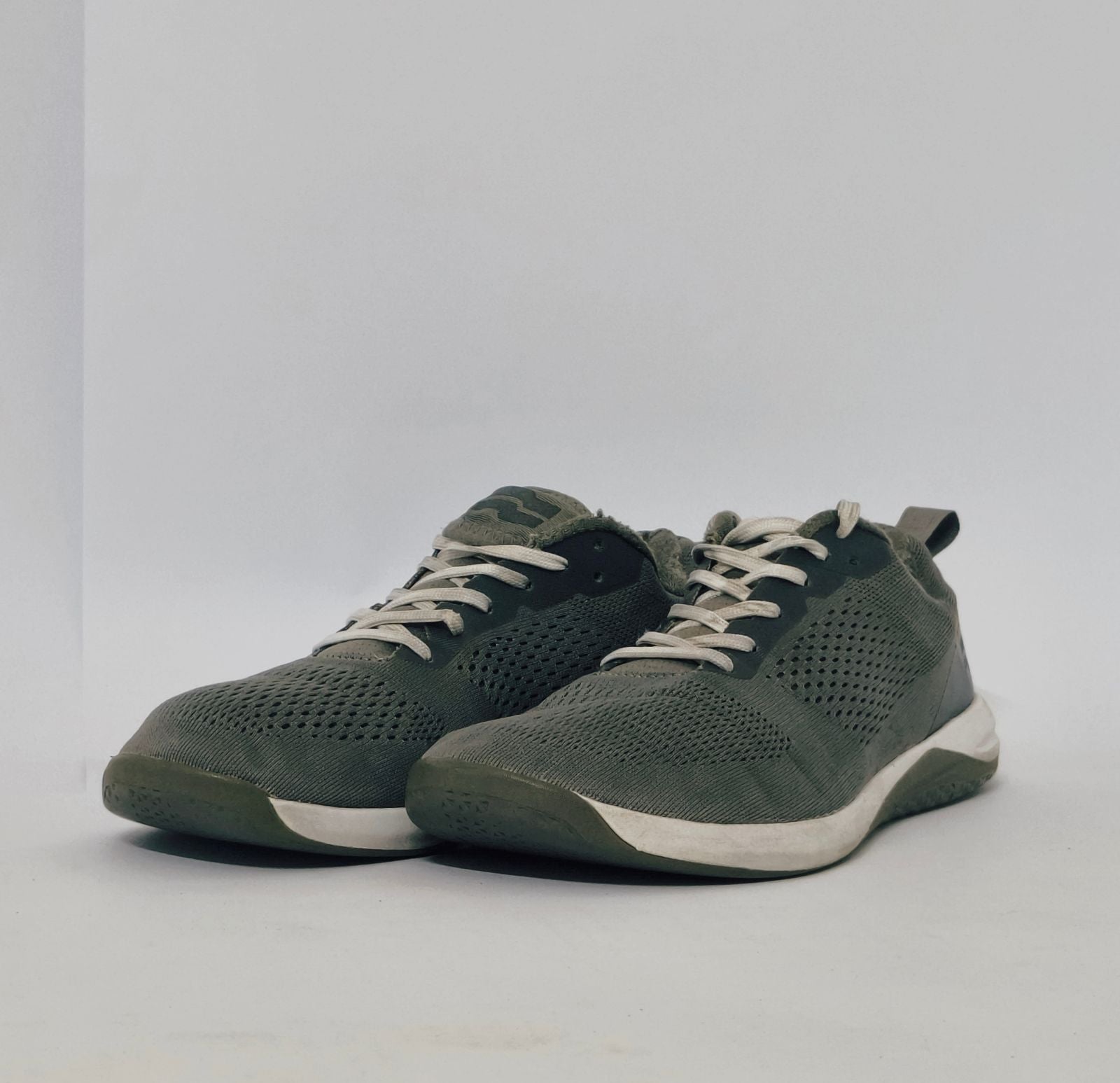Black athletic sneakers with breathable knit upper and lightweight cushioned sole in used condition size US 7.5